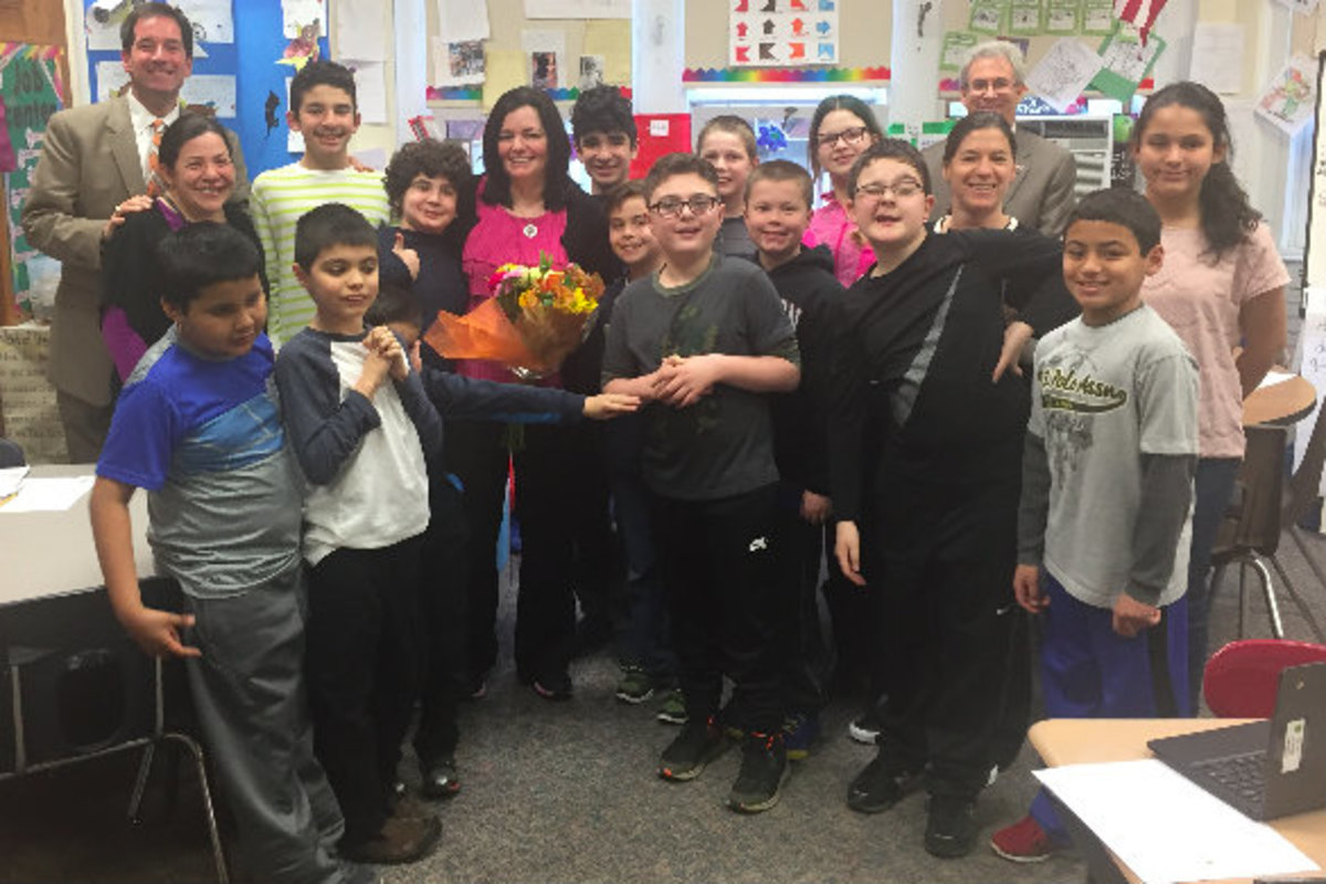 Kathy Davies is surounded by some of her students at Patrick M. Villano Elementary School. Davies started her career in the Emerson Public School district as a teaching assistant and is now a special education instructor.