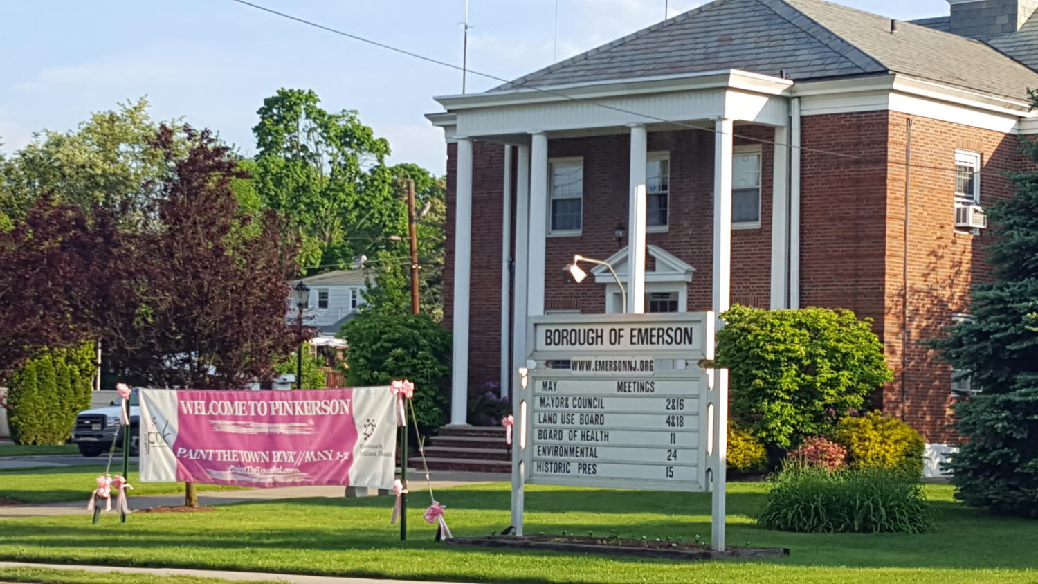 A huge pink and white sign welcomes drivers along Main Street in Emerson to